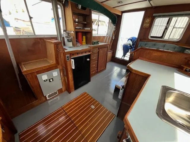 Slide: The Image of 1989 Maritime 340 Trawler interior with wooden cabinetry and modern amenities. - 24