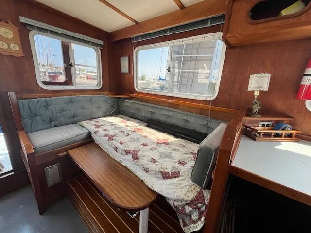 Slide: The Image of 1989 Maritime 340 Trawler interior with cozy seating, wooden accents, and nautical decor. - 25