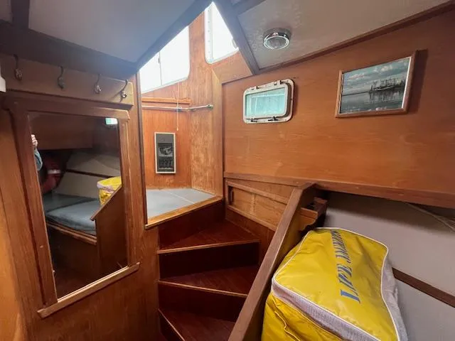 Slide: The Image of 1989 Maritime 340 Trawler interior with wooden stairs and cozy cabin space. - 32