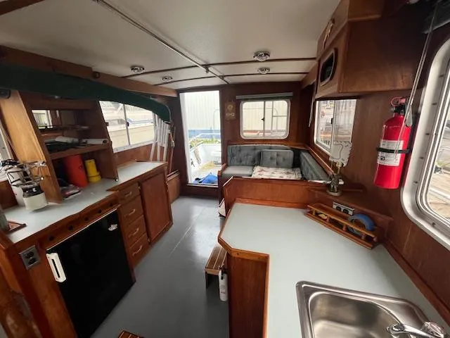 Slide: The Image of 1989 Maritime 340 Trawler interior with kitchen, seating area, and wooden cabinetry. - 35