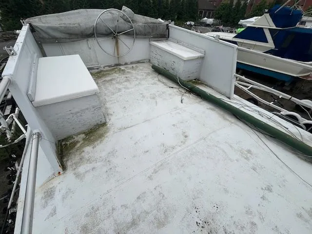 Slide: The Image of 1989 Maritime 340 Trawler deck with storage benches and steering wheel. - 37