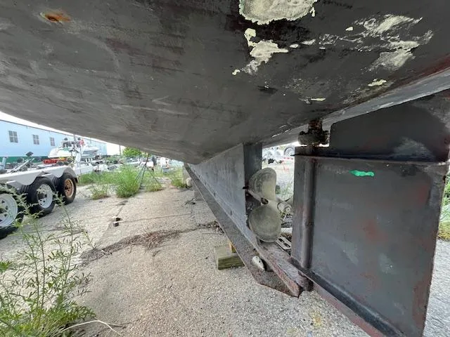 Slide: The Image of Underside view of a 1989 Maritime 340 Trawler, showing propeller and keel on dry land. - 40