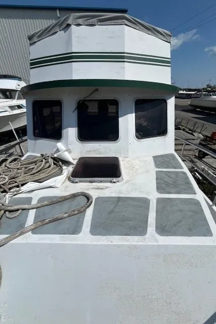 Slide: The Image of 1989 Maritime 340 Trawler with ropes on deck, docked near a warehouse. - 7