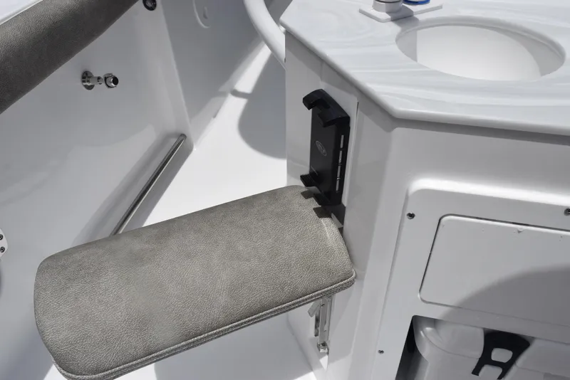 Slide: The Image of 2026 Sea Hunt Ultra 255 SE boat interior with cushioned seat and storage compartment. - 18