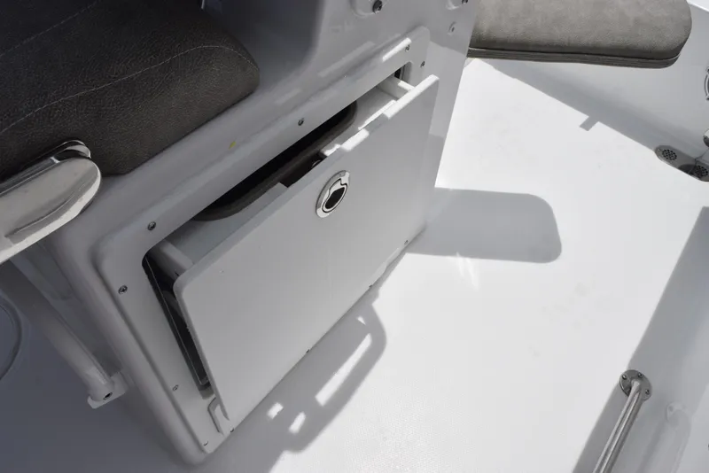 Slide: The Image of 2026 Sea Hunt Ultra 255 SE boat interior with storage compartment. - 22