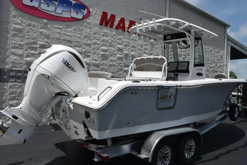 Slide: The Image of 2026 Sea Hunt Ultra 255 SE boat on trailer with Yamaha engine, parked outside dealership. - 4