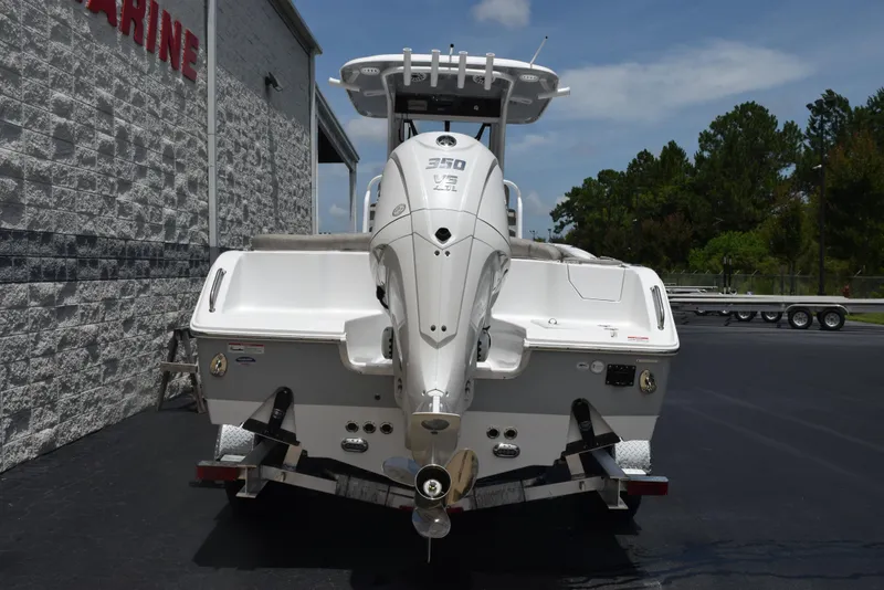 Slide: The Image of 2026 Sea Hunt Ultra 255 SE boat rear view, parked outdoors on a sunny day. - 5