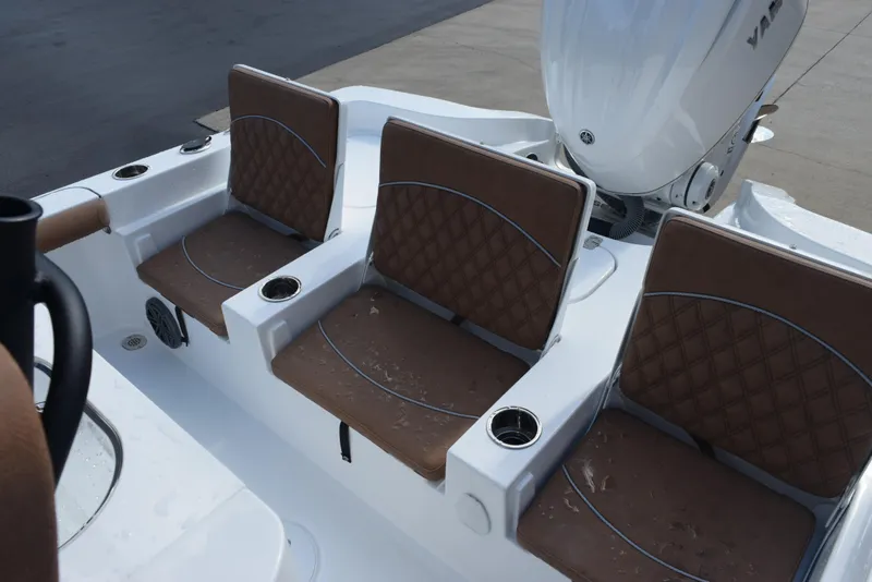 Slide: The Image of 2026 Sea Hunt BX 25 FS boat with brown cushioned seats and cup holders. - 11