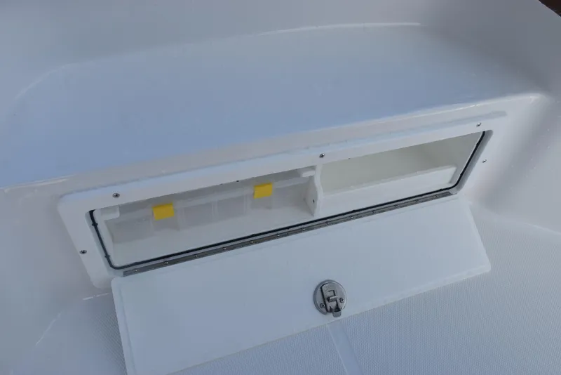 Slide: The Image of Storage compartment on 2026 Sea Hunt BX 25 FS boat, featuring a secure latch. - 16
