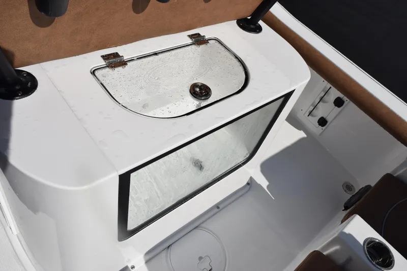 Slide: The Image of 2026 Sea Hunt BX 25 FS boat livewell with transparent lid and secure latch. - 20