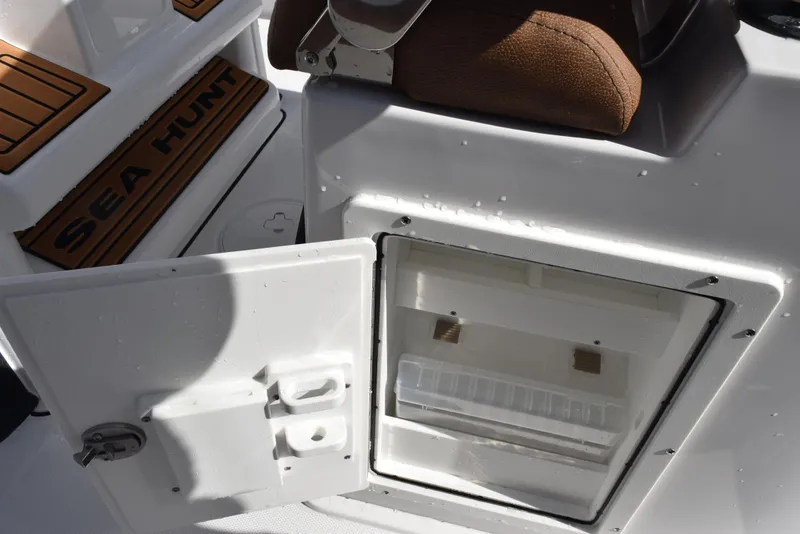 Slide: The Image of 2026 Sea Hunt BX 25 FS boat with open storage compartment. - 21