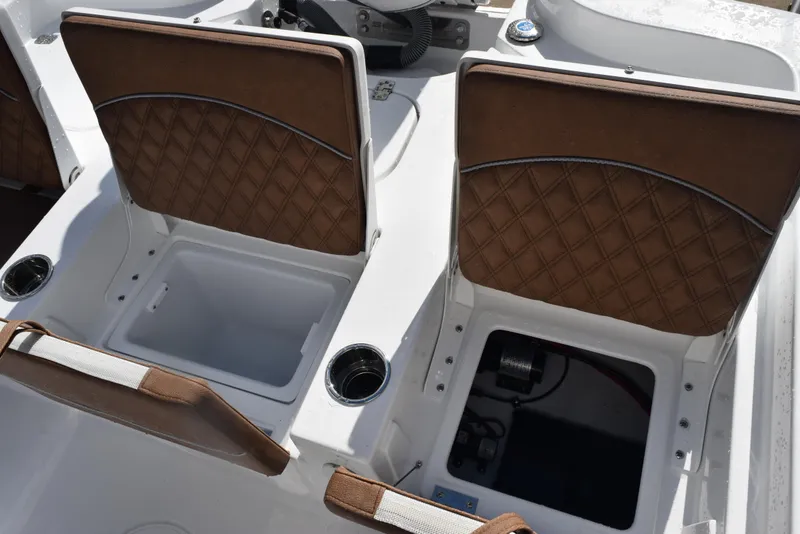 Slide: The Image of 2026 Sea Hunt BX 25 FS boat interior with brown cushioned seats and storage compartments. - 22