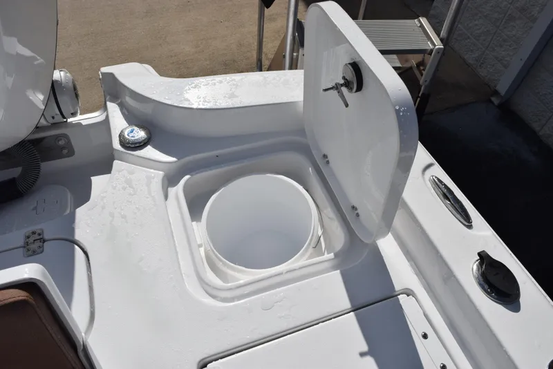 Slide: The Image of 2026 Sea Hunt BX 25 FS boat with open storage compartment on deck. - 24