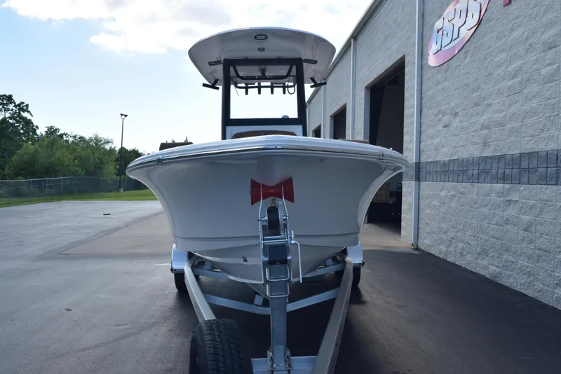 Slide: The Image of 2026 Sea Hunt BX 25 FS boat on trailer, parked outside a building. - 3