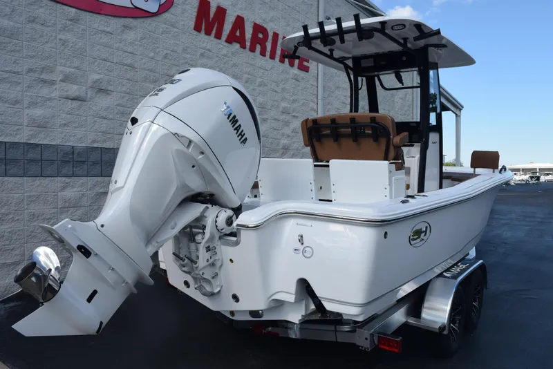 Slide: The Image of 2026 Sea Hunt BX 25 FS boat with Yamaha engine, parked outside a marine store. - 4