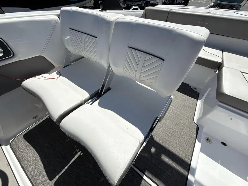 Slide: The Image of 2022 Glastron GTD 245 boat interior with white cushioned seats. - 13