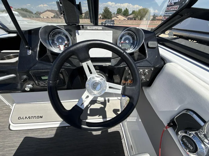 Slide: The Image of 2022 Glastron GTD 245 boat dashboard with steering wheel and gauges. - 14