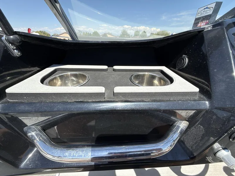 Slide: The Image of 2022 Glastron GTD 245 boat with dual cup holders and sleek black interior design. - 18