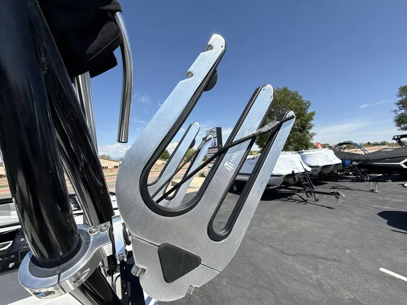 Slide: The Image of Wakeboard rack on a 2022 Glastron GTD 245 boat under clear blue sky. - 22