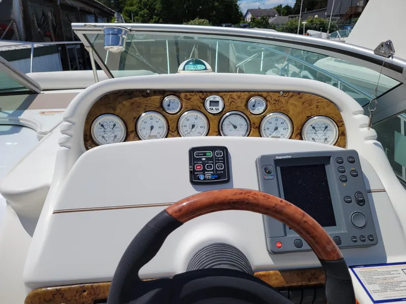 Slide: The Image of 2003 Larson 310 boat dashboard with gauges and navigation system. - 11