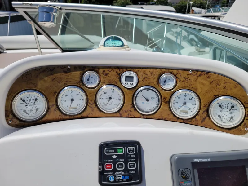 Slide: The Image of Dashboard of a 2003 Larson 310 boat with multiple gauges and controls. - 12