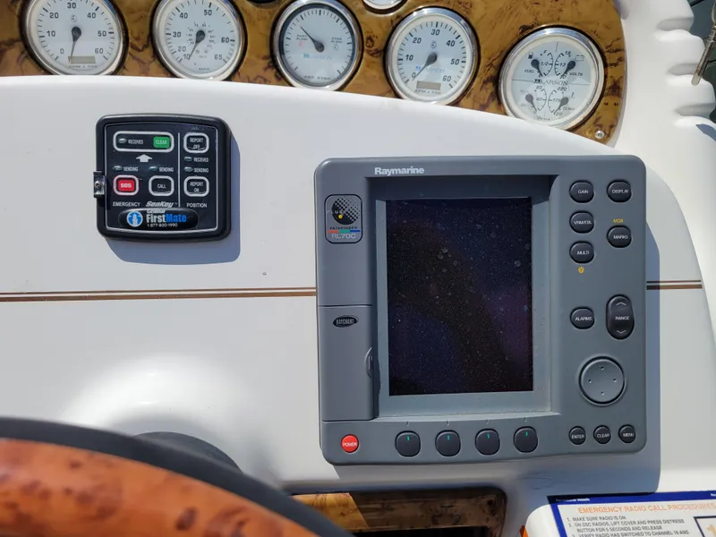 Slide: The Image of Control panel of a 2003 Larson 310 boat with gauges and navigation system. - 13