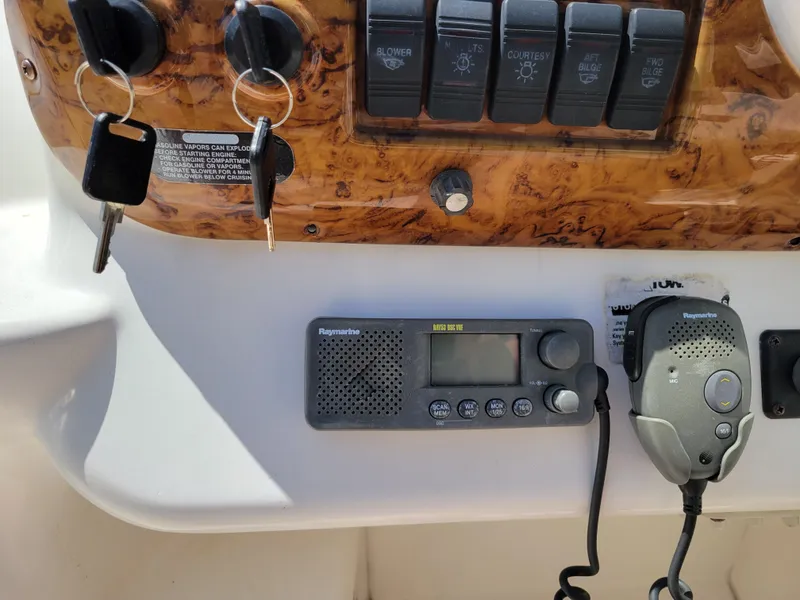 Slide: The Image of Control panel of a 2003 Larson 310 boat with radio and keys. - 16