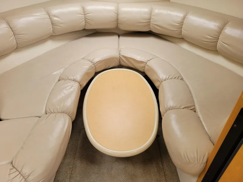 Slide: The Image of Luxurious beige leather seating area with oval table in 2003 Larson 310 boat. - 25
