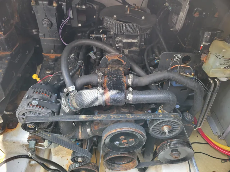 Slide: The Image of Engine compartment of a 2003 Larson 310 boat, showing belts and hoses. - 36