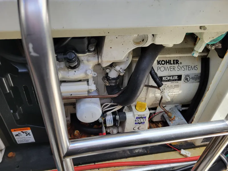 Slide: The Image of Engine compartment of a 2003 Larson 310 boat featuring a Kohler power system. - 38