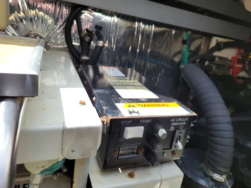 Slide: The Image of Control panel in a 2003 Larson 310 boat engine compartment, featuring AC circuit breaker. - 39
