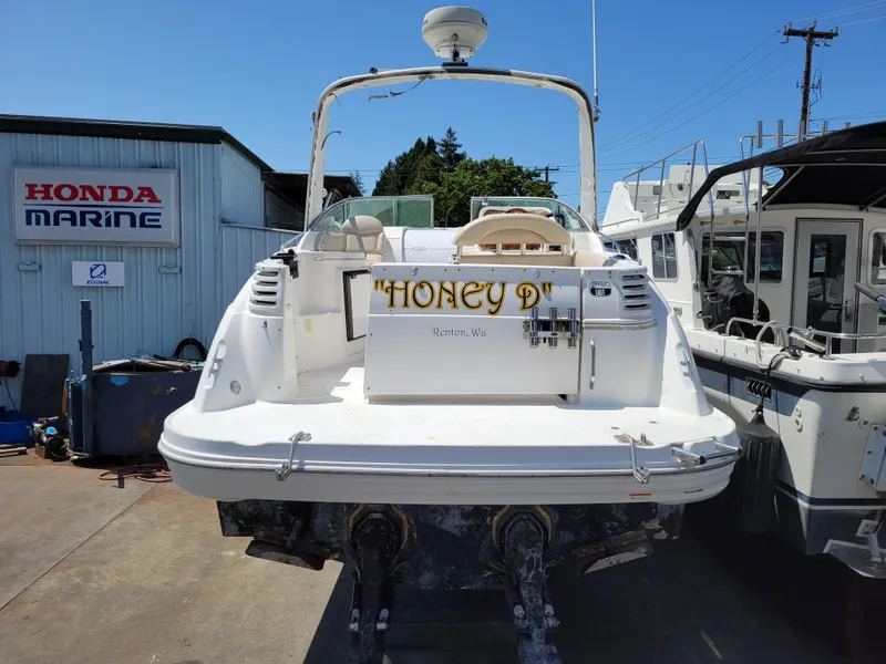Slide: The Image of 2003 Larson 310 boat docked at marina under sunny sky. - 4