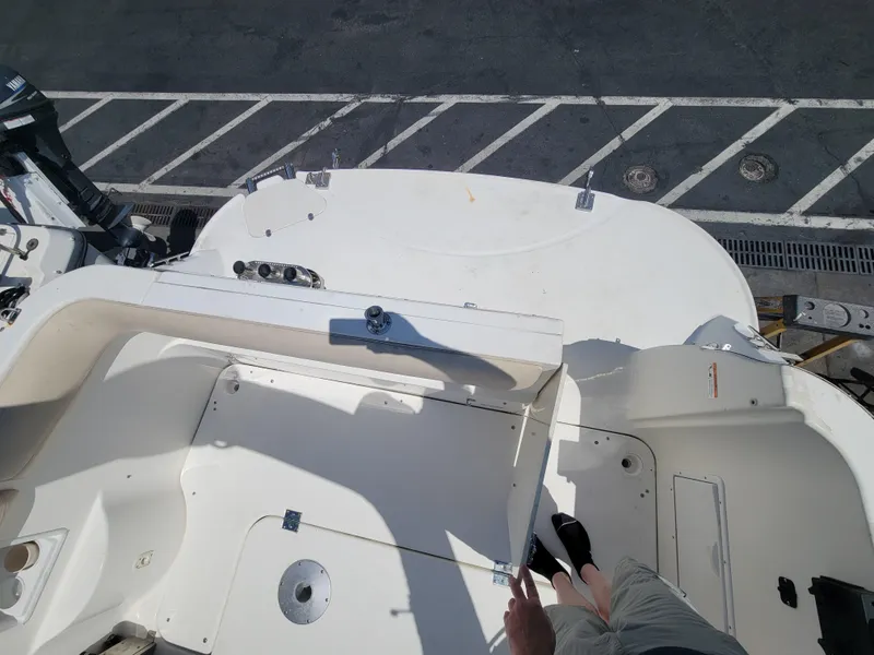 Slide: The Image of 2003 Larson 310 boat deck view with parking lot background. - 6