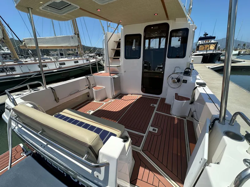 Slide: The Image of 2023 Ranger Tugs R-31 CB boat deck with seating, docked at marina. - 10