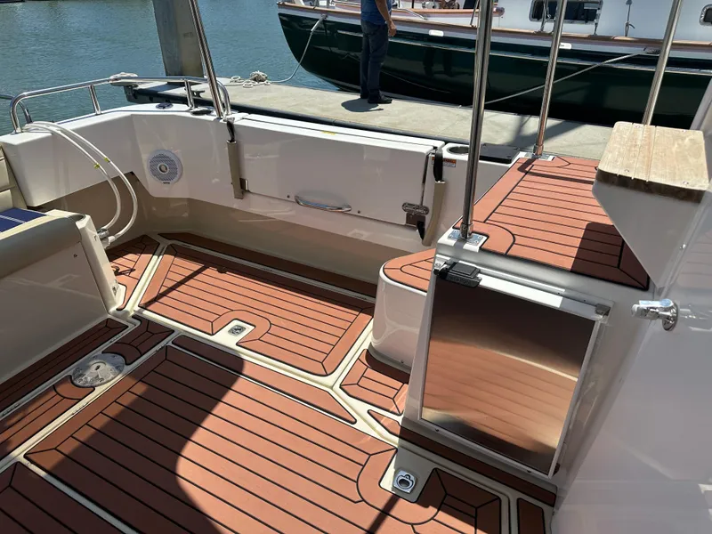 Slide: The Image of 2023 Ranger Tugs R-31 CB boat deck with wood finish and stainless steel accents. - 12