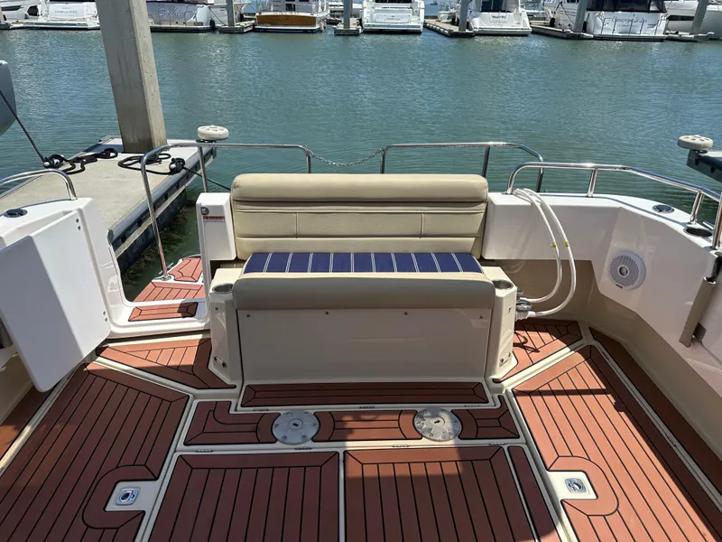 Slide: The Image of 2023 Ranger Tugs R-31 CB boat deck with seating, docked at marina. - 13