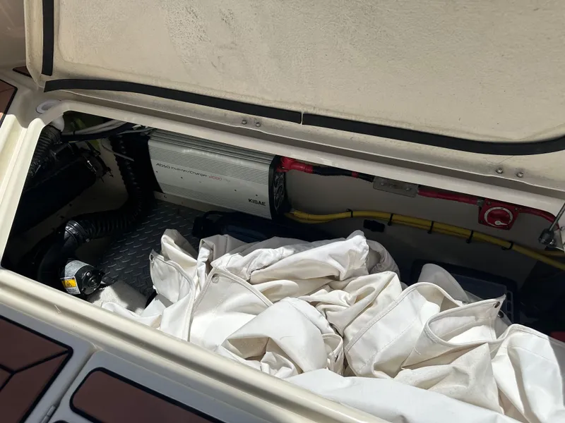 Slide: The Image of 2023 Ranger Tugs R-31 CB storage compartment with equipment and fabric. - 14