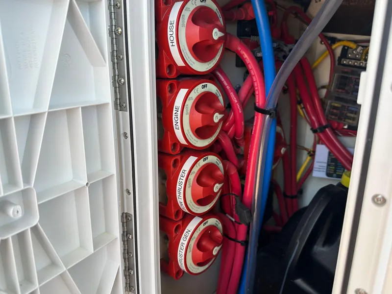 Slide: The Image of Electrical panel with red switches and wiring on a 2023 Ranger Tugs R-31 CB boat. - 15