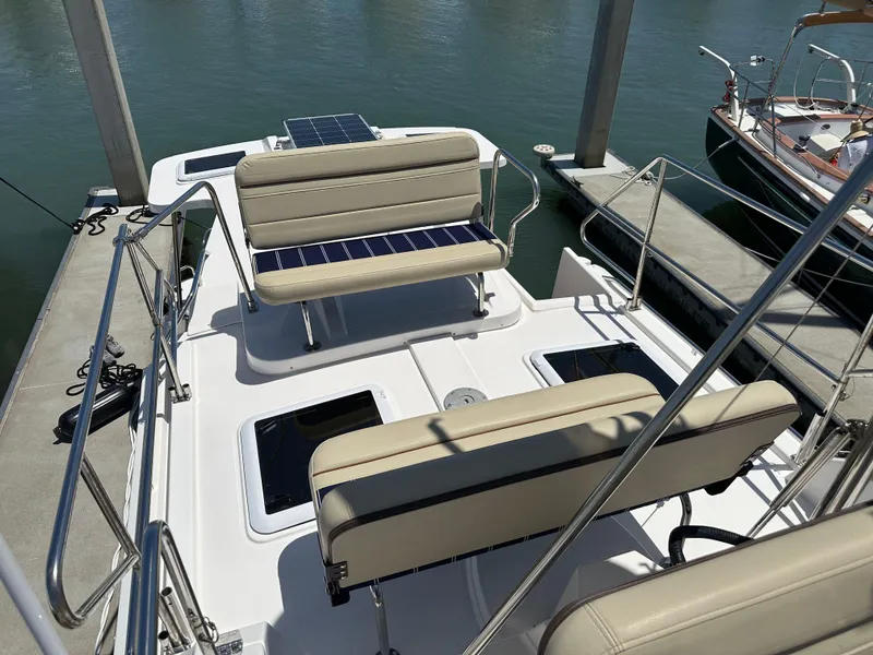 Slide: The Image of 2023 Ranger Tugs R-31 CB boat with beige seating and solar panels at a dock. - 27