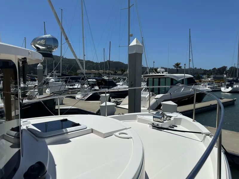 Slide: The Image of 2023 Ranger Tugs R-31 CB docked at a marina with other boats. - 32