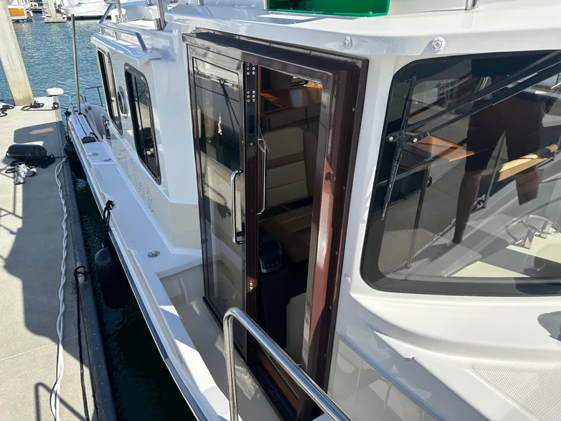 Slide: The Image of 2023 Ranger Tugs R-31 CB boat docked, showcasing sleek design and modern features. - 36