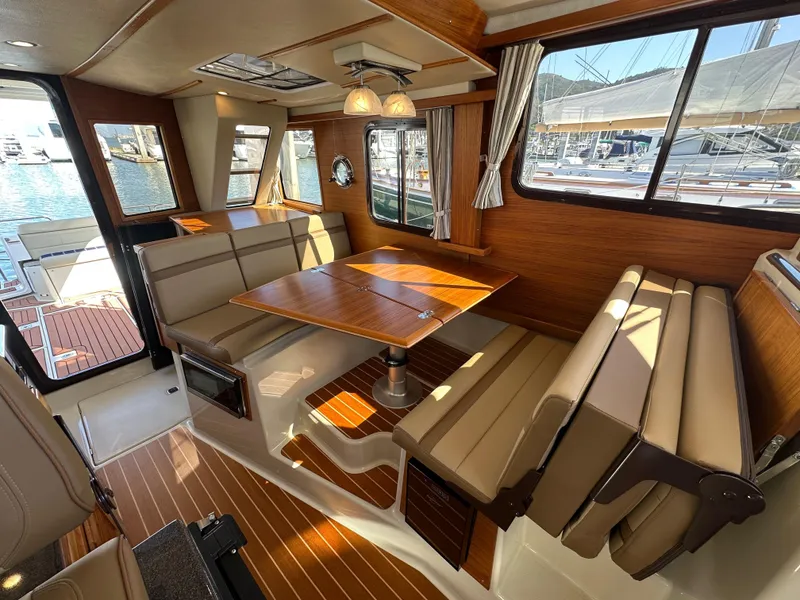 Slide: The Image of Interior of 2023 Ranger Tugs R-31 CB, featuring elegant wood finishes and comfortable seating. - 40