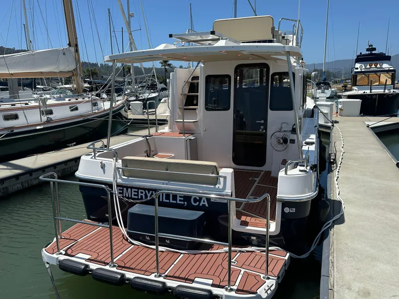 Slide: The Image of 2023 Ranger Tugs R-31 CB docked at marina, rear view. - 8