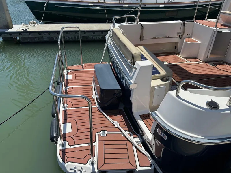 Slide: The Image of 2023 Ranger Tugs R-31 CB boat with teak deck at a marina. - 9