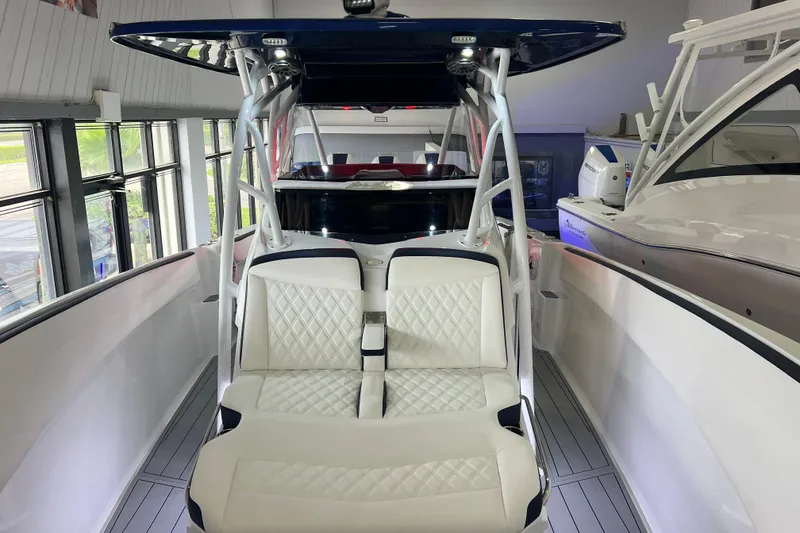 Slide: The Image of 2026 Nor-Tech 340 Sport boat interior with white quilted seating and modern design. - 10