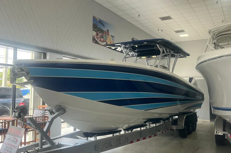 Slide: The Image of 2026 Nor-Tech 340 Sport boat interior with open storage compartment in showroom. - 12