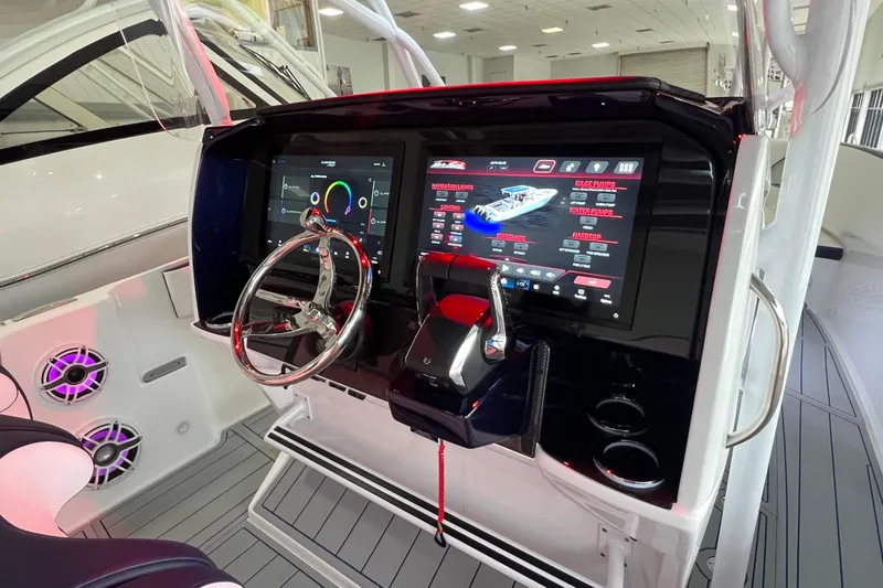 Slide: The Image of 2026 Nor-Tech 340 Sport dashboard with advanced touchscreen controls and sleek steering wheel. - 14