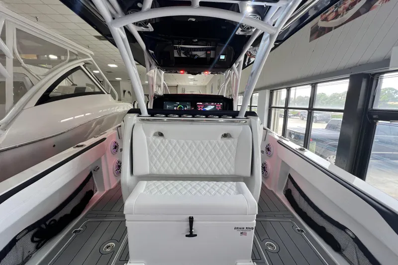 Slide: The Image of 2026 Nor-Tech 340 Sport boat interior with luxurious seating and powerful Mercury engines. - 18