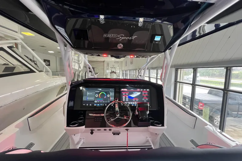 Slide: The Image of 2026 Nor-Tech 340 Sport boat interior with white seating and modern dashboard. - 19