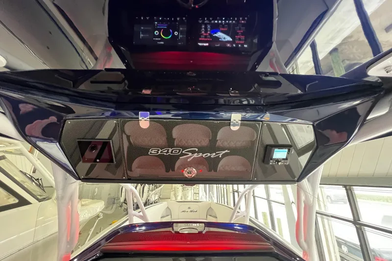 Slide: The Image of 2026 Nor-Tech 340 Sport boat interior with advanced dashboard and steering wheel. - 20